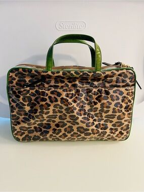 Brand new. Large Kate Spade cosmetic bag. Leopard print with green lining/trim.